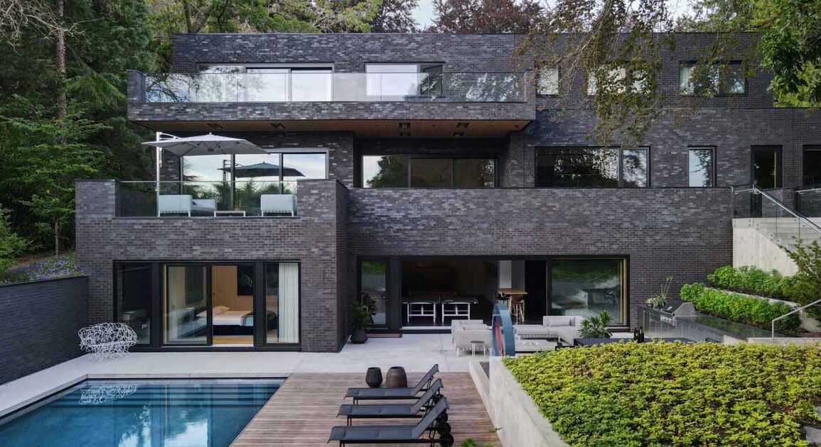 a-dark-brick-exterior-for-a-home-surrounded-by-trees