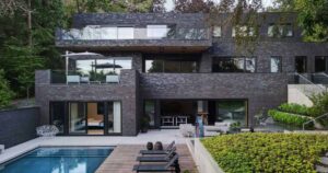 a-dark-brick-exterior-for-a-home-surrounded-by-trees