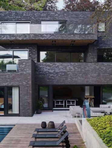 a-dark-brick-exterior-for-a-home-surrounded-by-trees