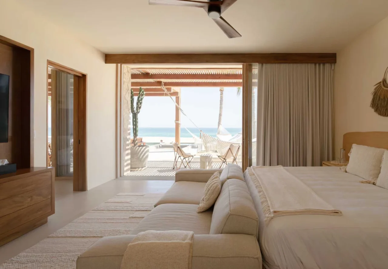 Bedroom with a neutral palette and a view of the beach