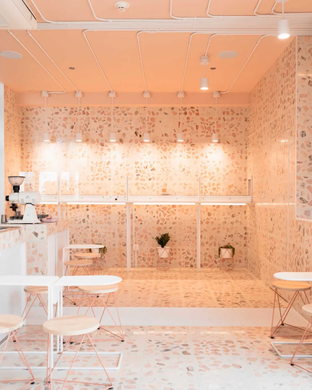 Custom-coloured terrazzo tiles combined with white perforated metal and glass