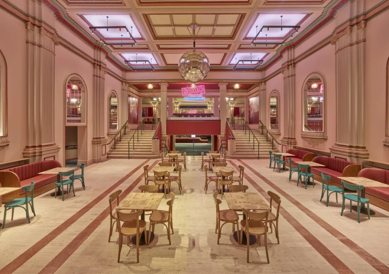 Double-height foyer restored to its original bright pink colour