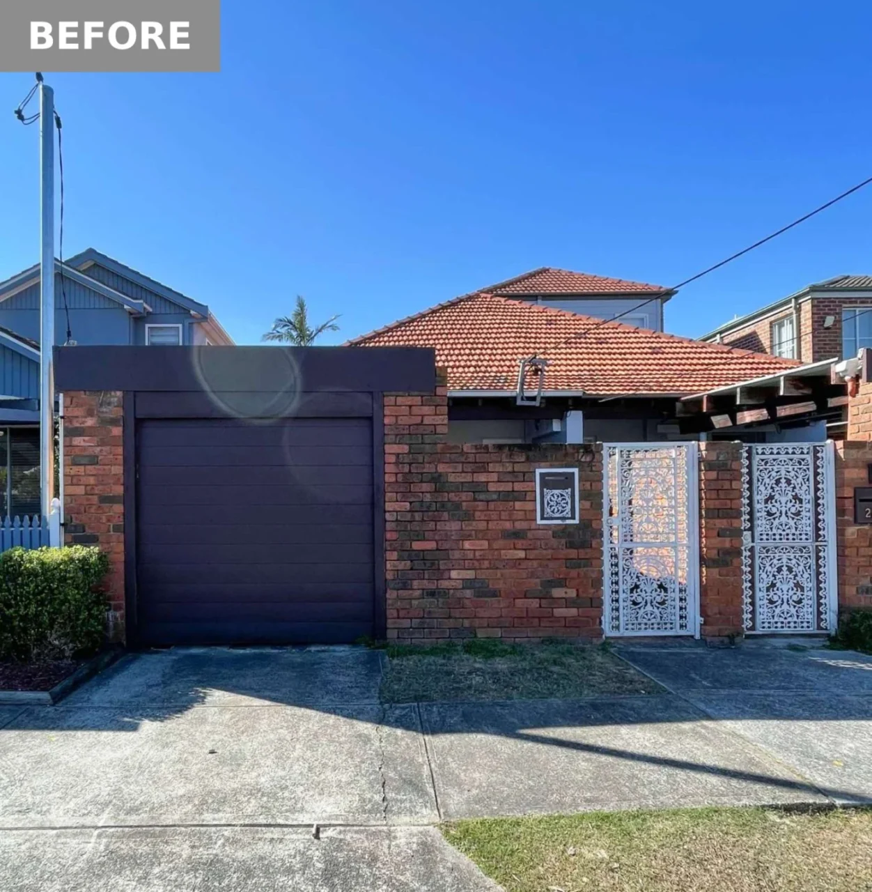 Before: the dated red brick facade with ornate gates, before the renovation