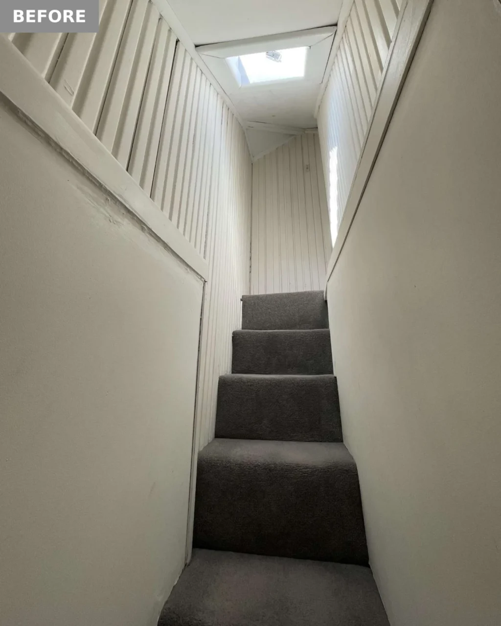 Before: narrow, steep staircase with dark grey carpet and a small skylight