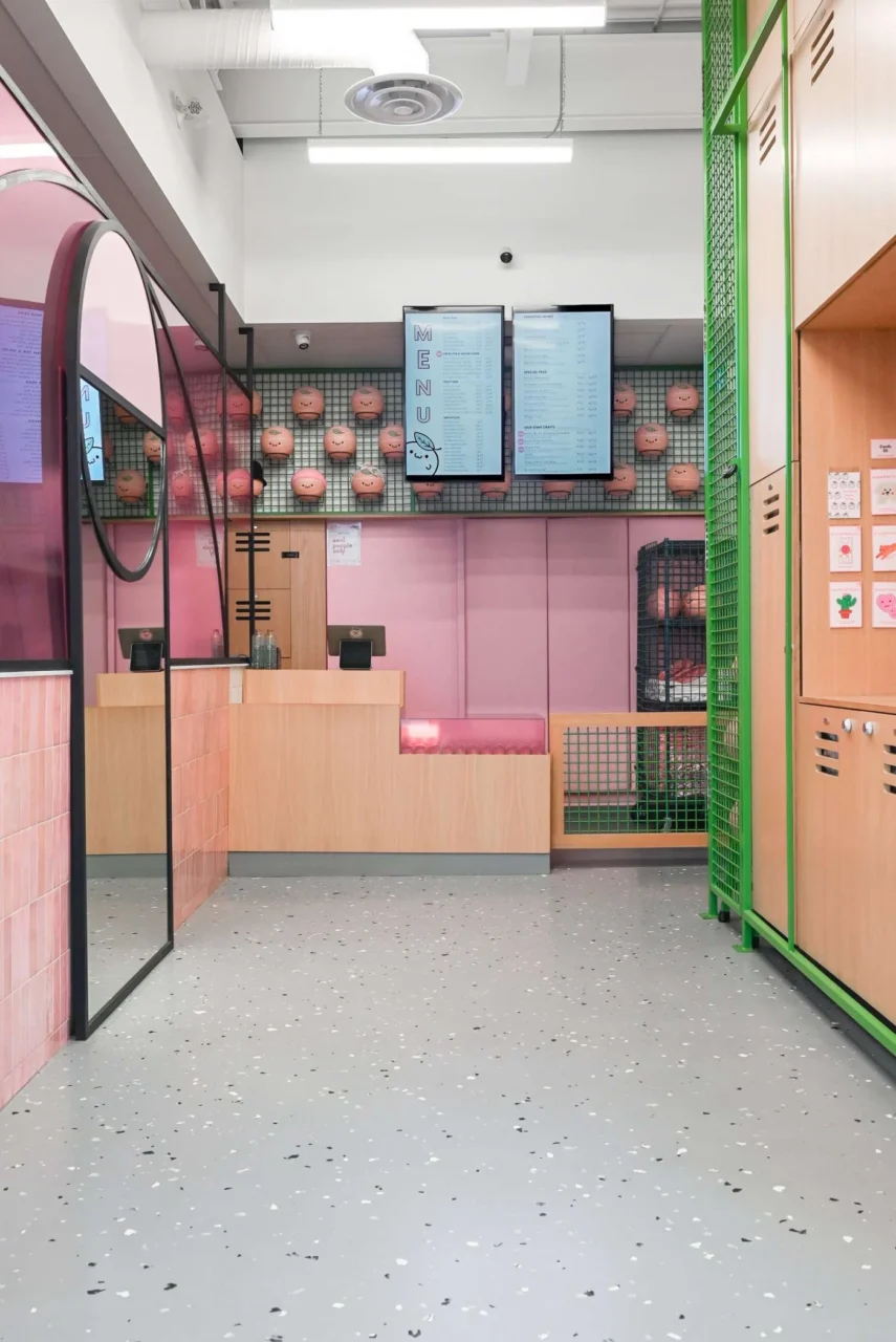 Wall of pastel basketballs above grid panelling and green lockers