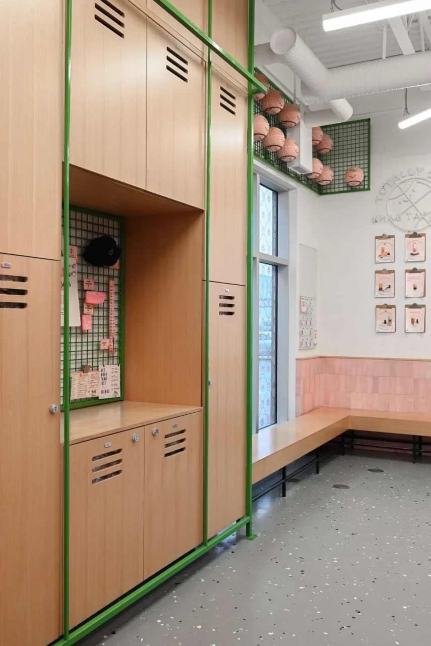 Green lockers, wood finishes and branded merchandise on display in the shop