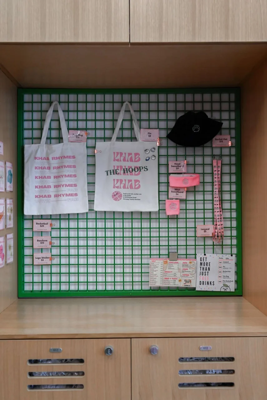 Locker wall with green accents, wood finishes and merchandise on display