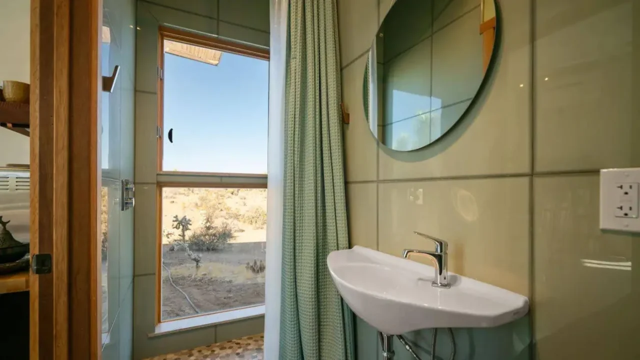 Small bathroom with windows framing desert views