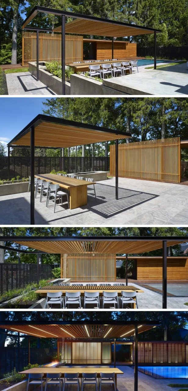 Poolside dining table under a wood and metal pergola by Amantea Architects