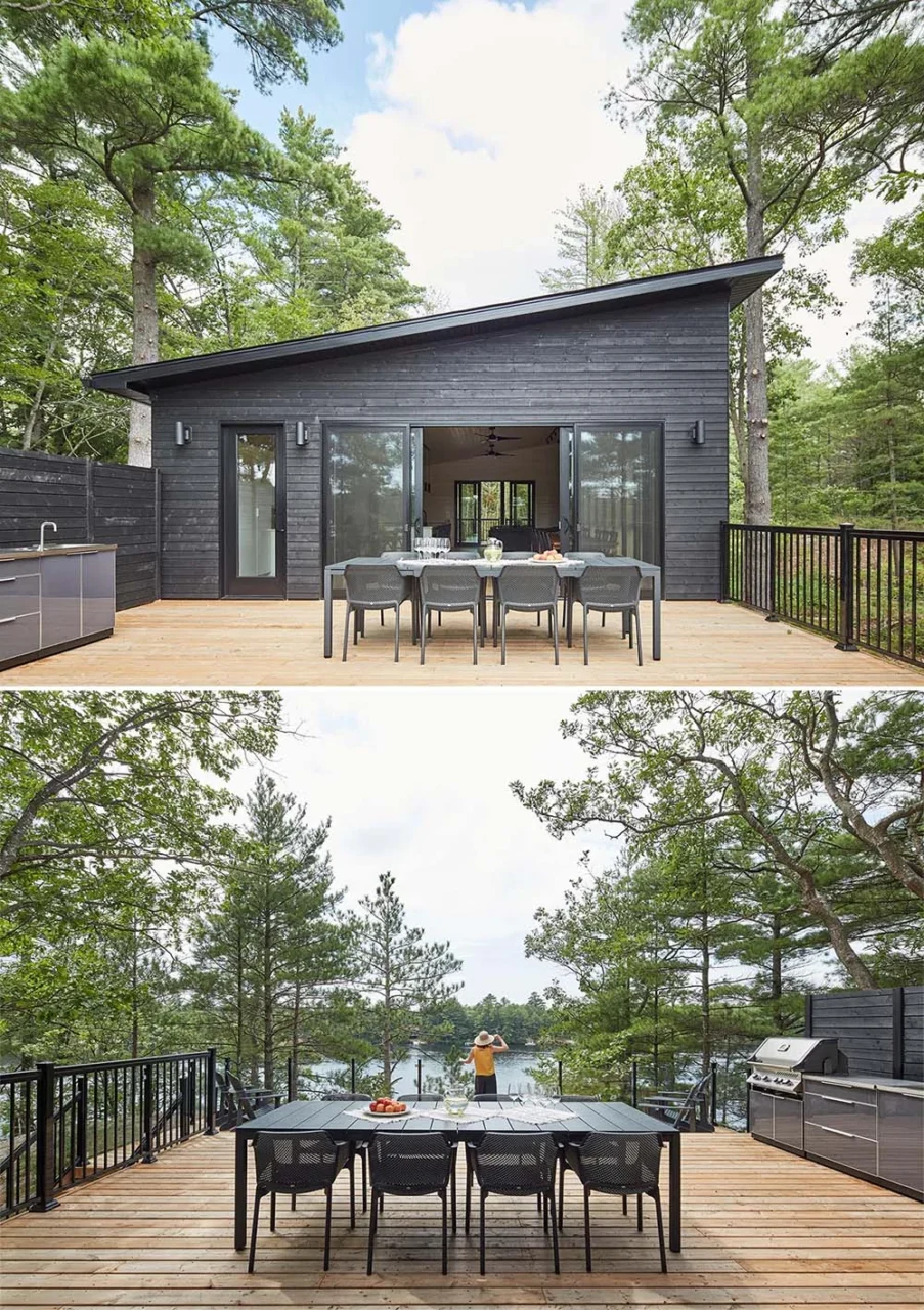 Cabin deck with a built-in BBQ, dining table and glass railings by Solares Architecture