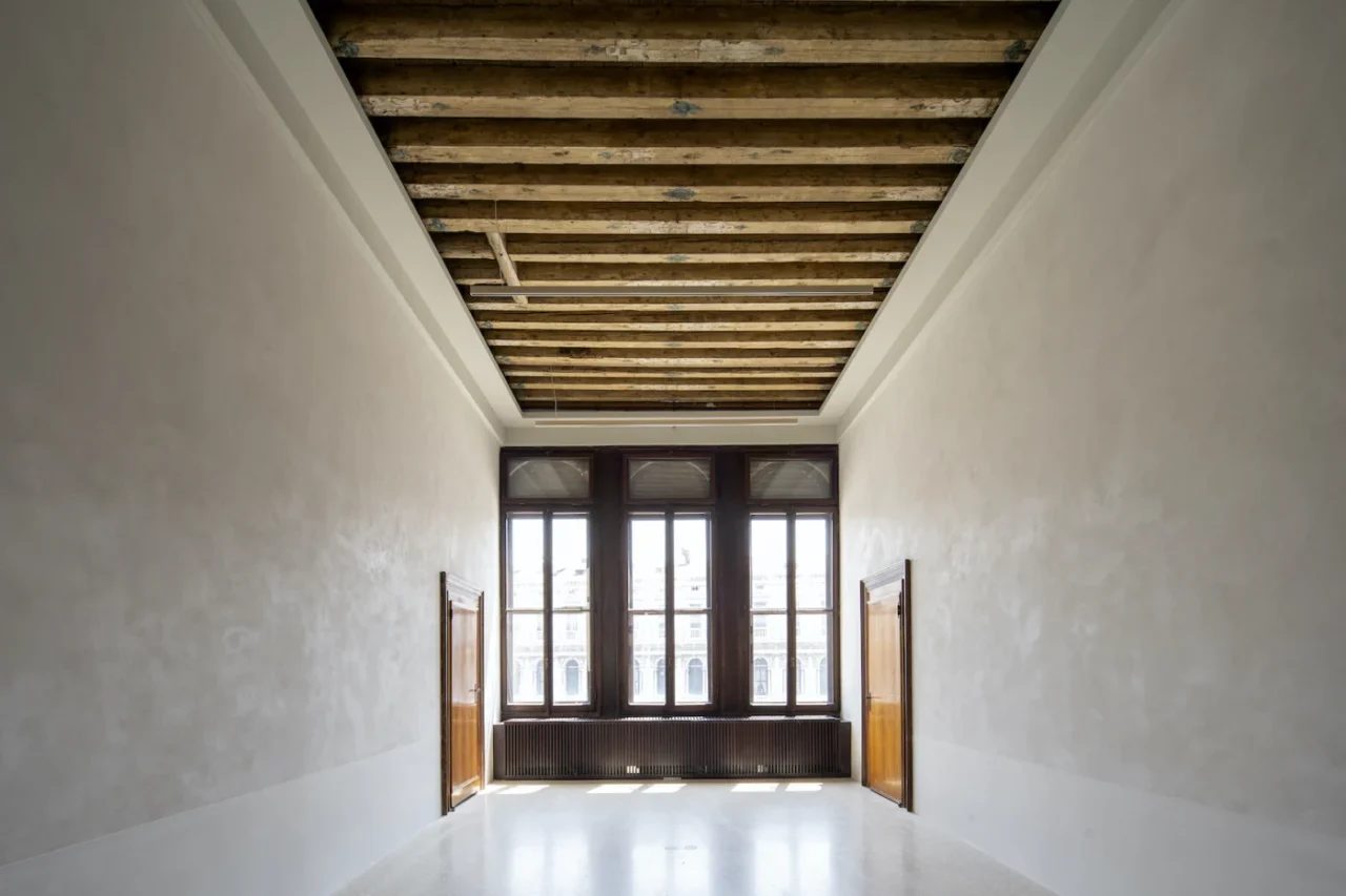 Gallery enfilade of San Marco Art Centre with marmorino walls and white terrazzo floor