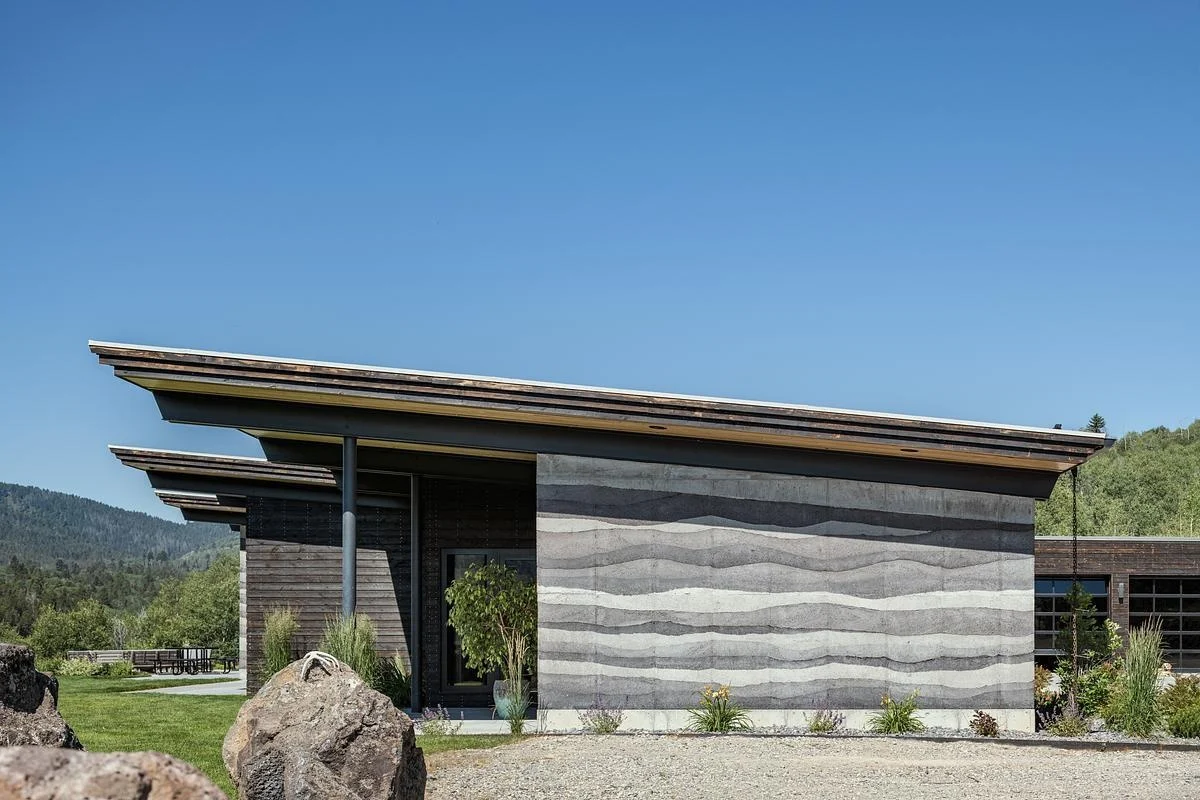 Thick stabilized rammed earth walls with horizontal layers on the exterior