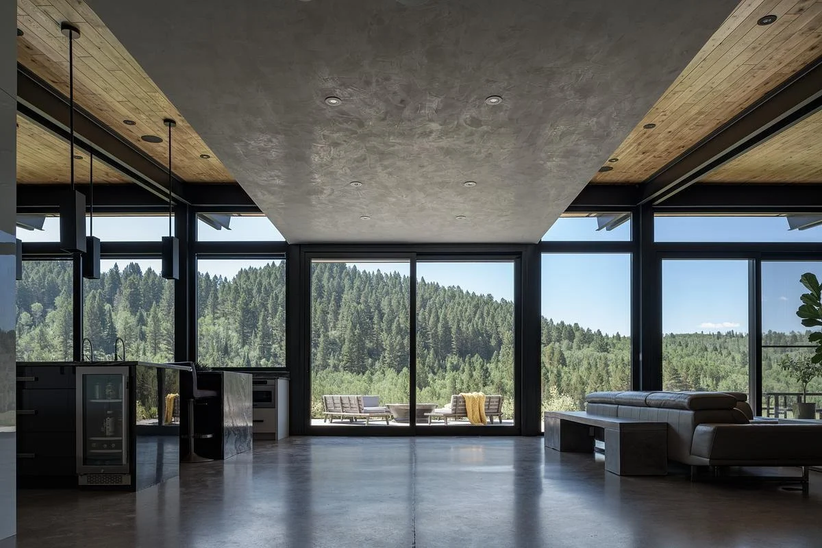 Floor-to-ceiling windows looking out over the high-desert landscape
