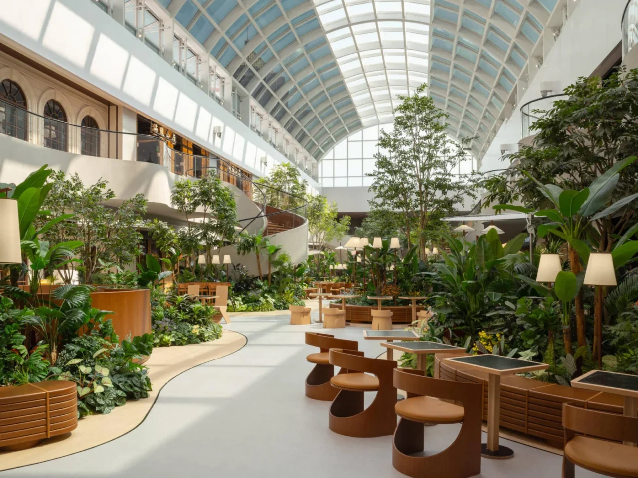 Indoor garden dining plaza on the 7th floor of Deji Plaza in Nanjing under an arched glass skylight