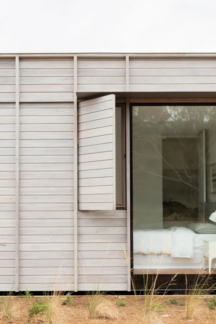 Timber facade of Courtyard House with the shutter opened like a page