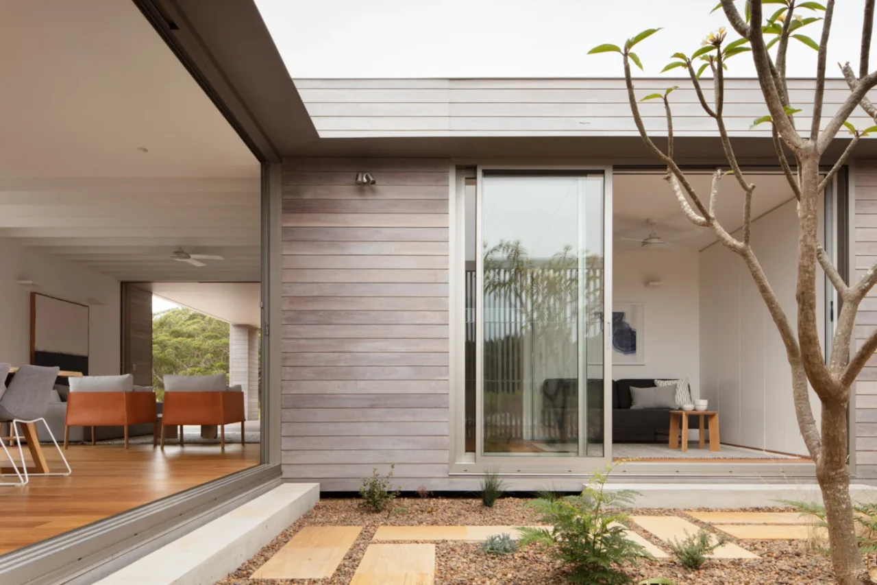 View from the courtyard into the living room with timber floors