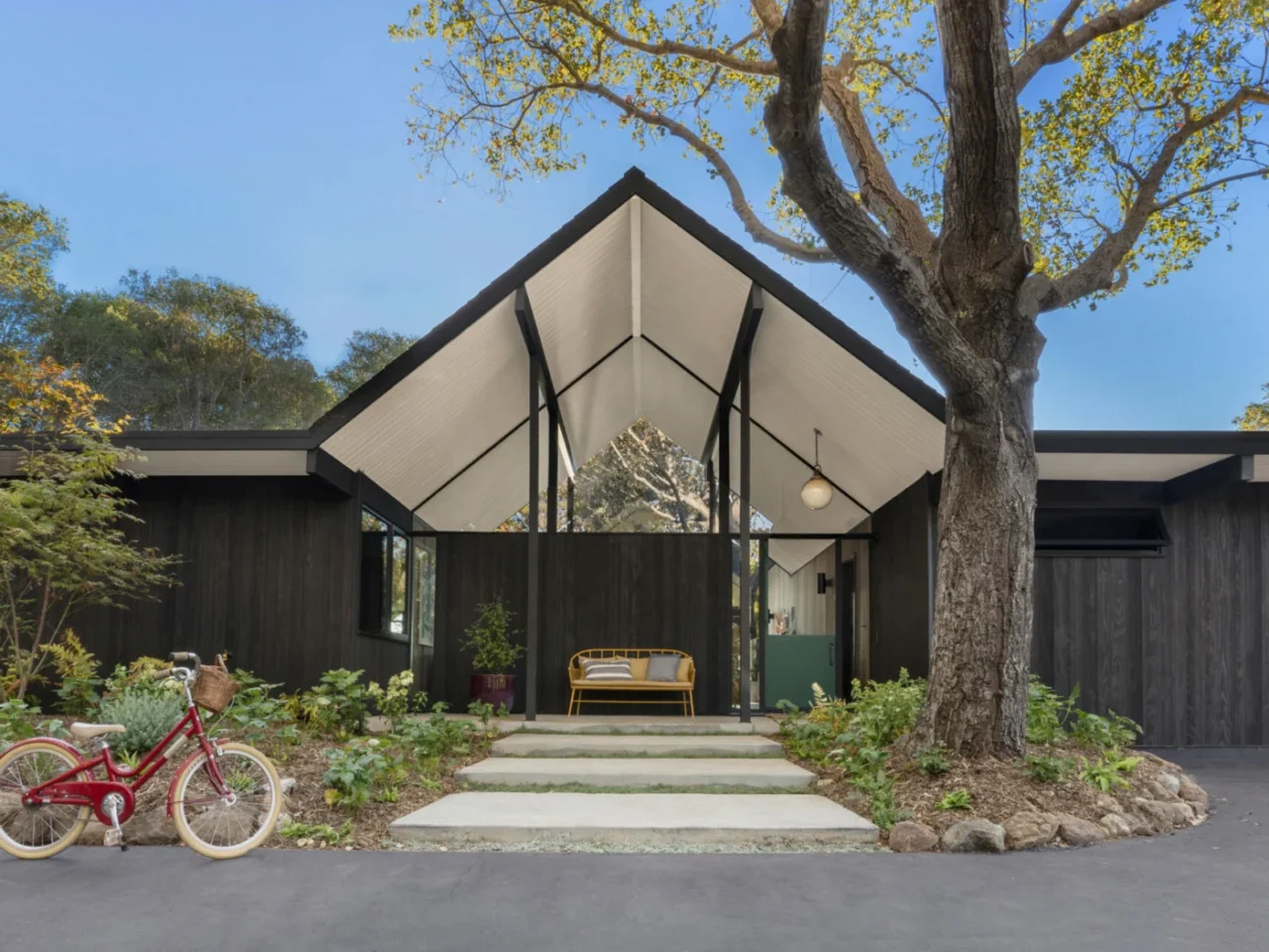 Renovated 1971 Eichler home in Palo Alto with a central gable and charred timber siding