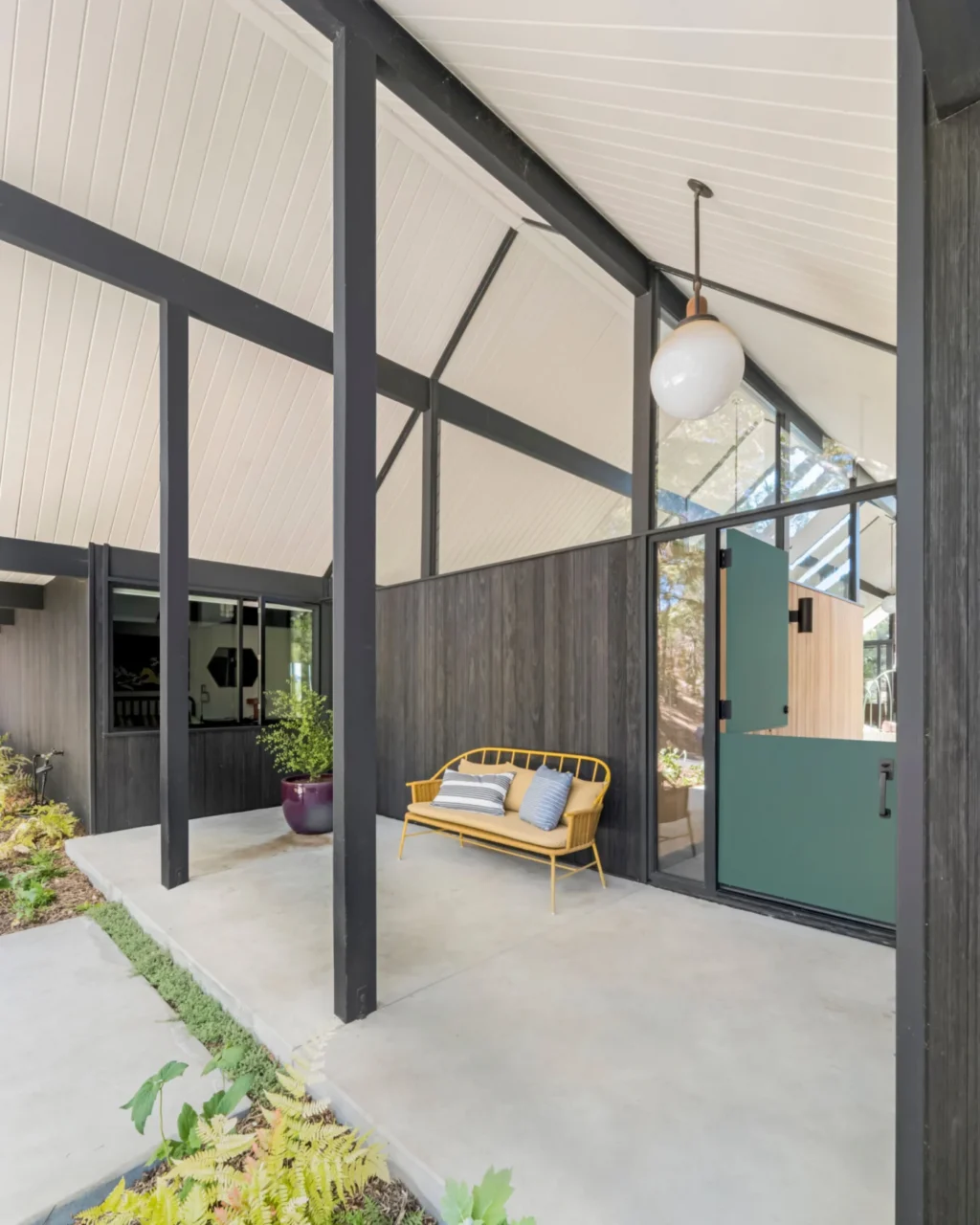 Entry porch under the gable with transom windows and a custom Dutch door