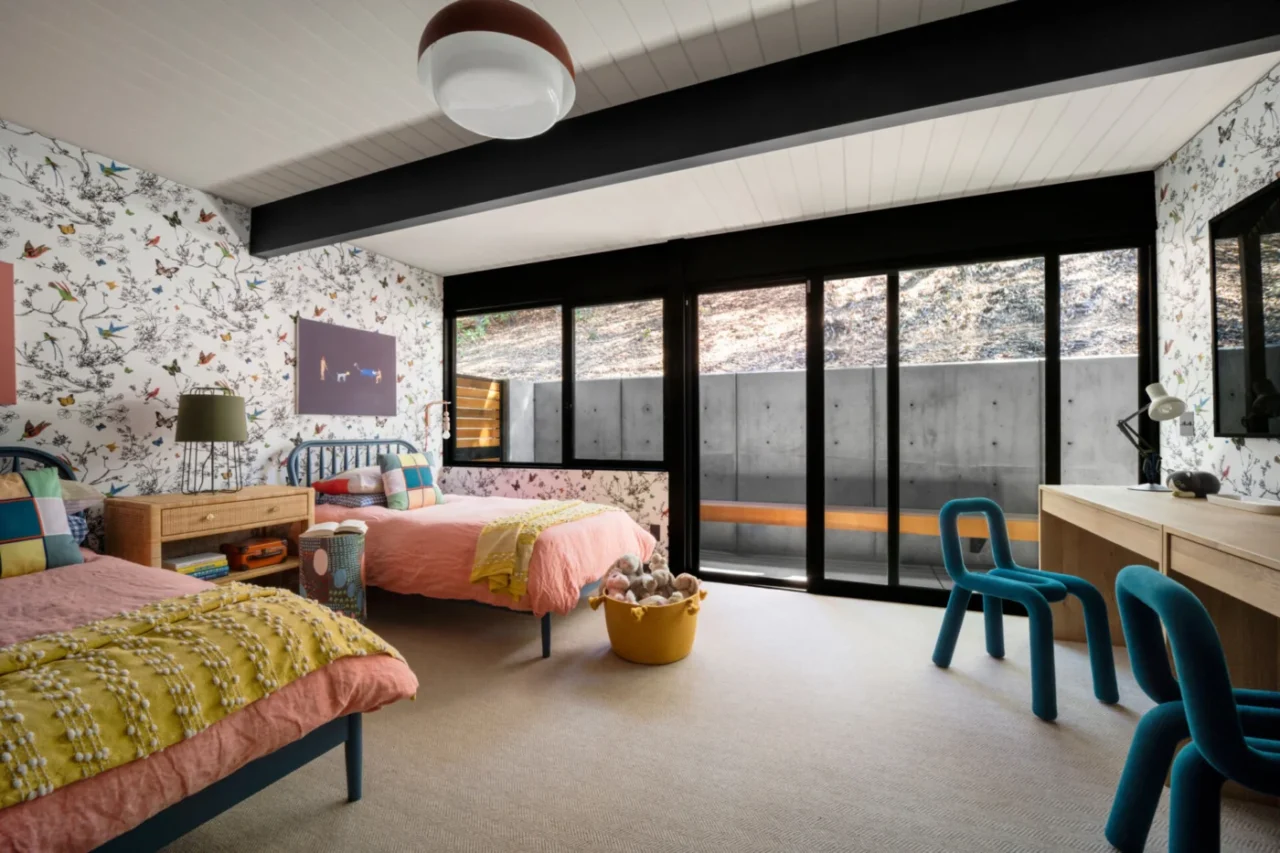 Children's bedroom with butterfly wallpaper and a built-in desk