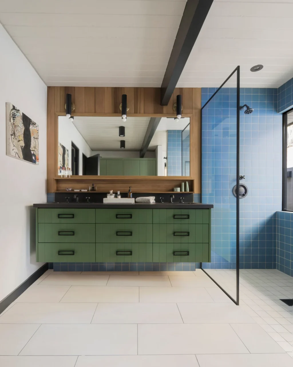 Primary bathroom with a green vanity, blue wall tiles and ceramic floor