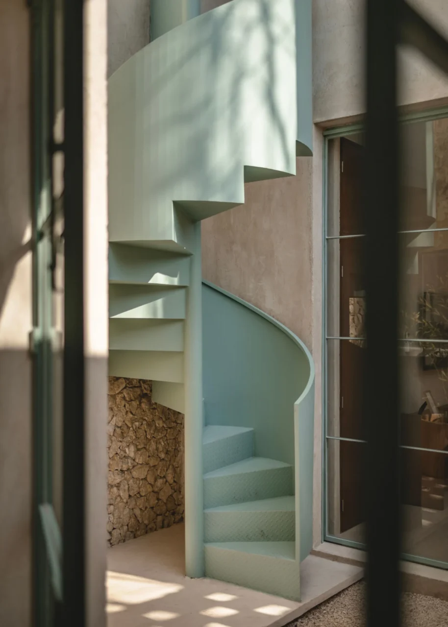 Pastel green spiral staircase inside one of the modules