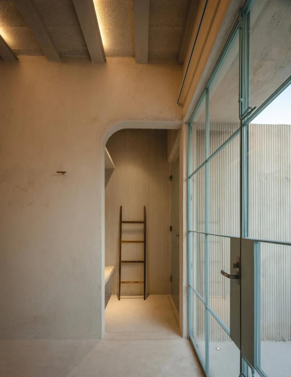 Upstairs glass walls and doors framed in sky-blue painted steel