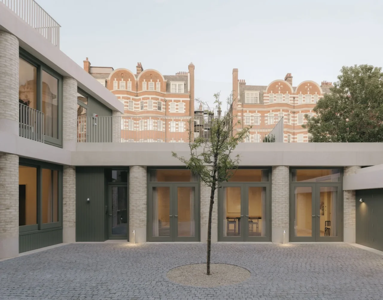 New extension in pale brick with rounded piers and pre-cast concrete lintels