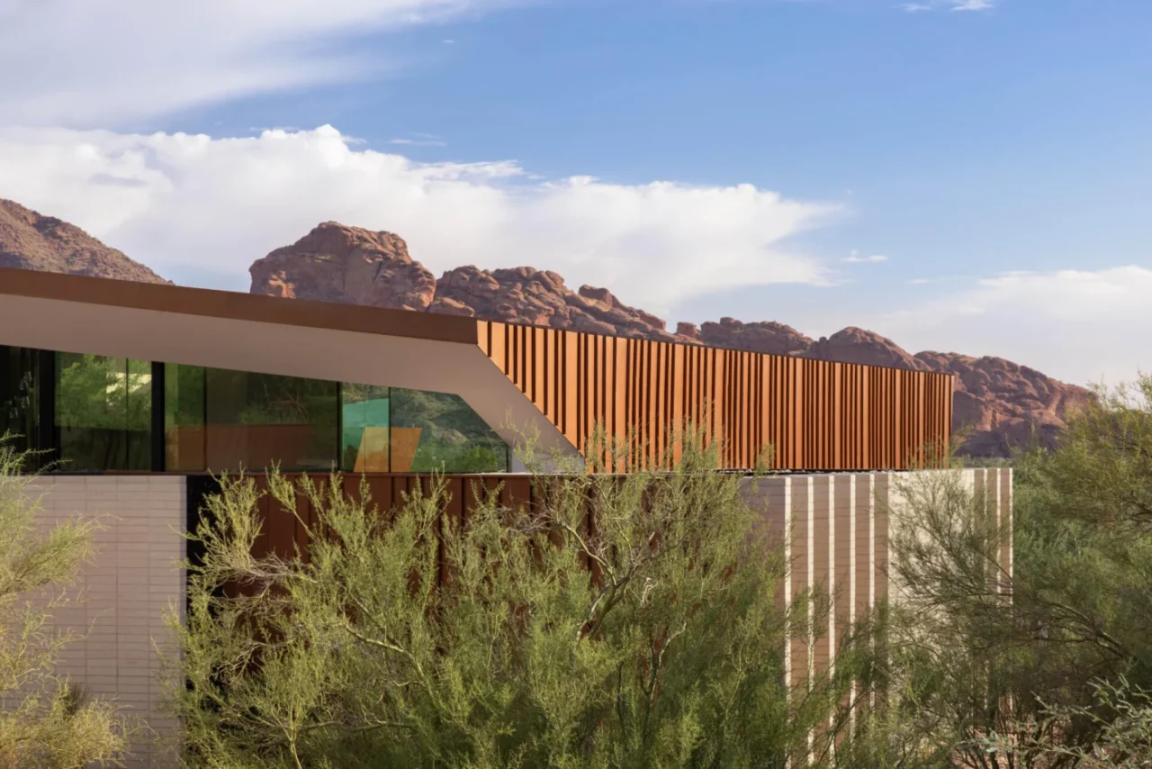 Weathered metal shell of the desert house sheltering a glazed interior