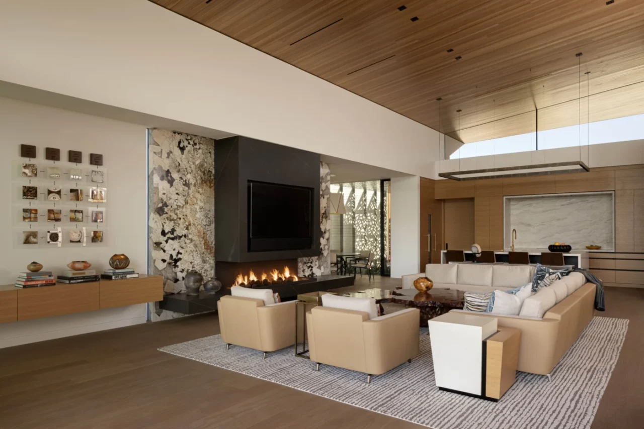 Great room with a fireplace and wide glazing facing Camelback Mountain
