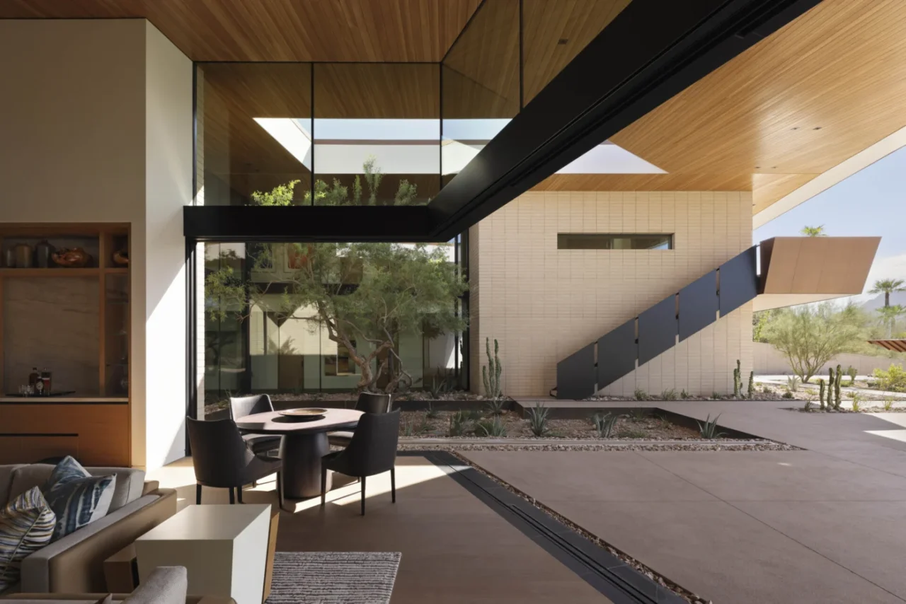 Glass walls opening the living spaces to terraces and a courtyard garden