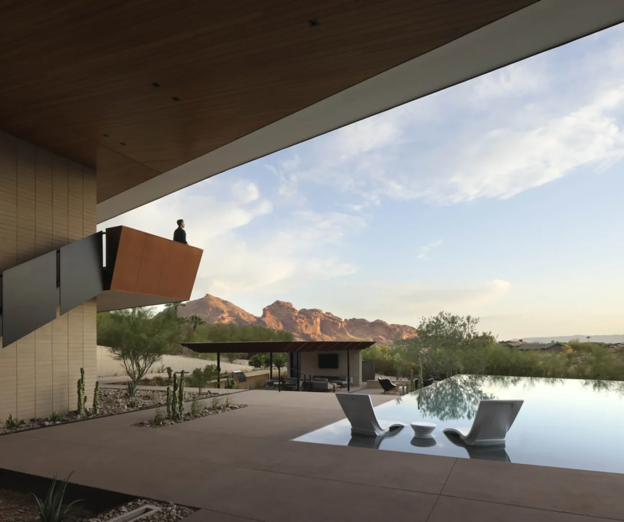 Infinity-edge pool reflecting the sky at the Desert Geode Residence