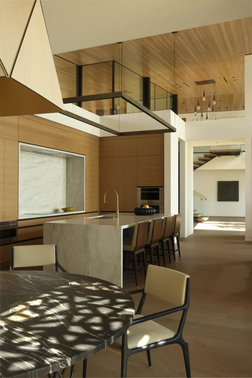 Kitchen in warm wood and stone near the open living spaces