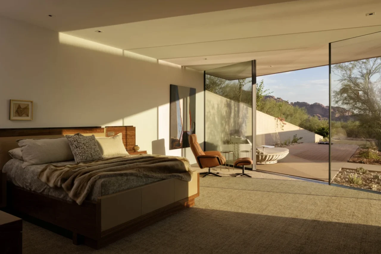 Bedroom with large windows framing the desert