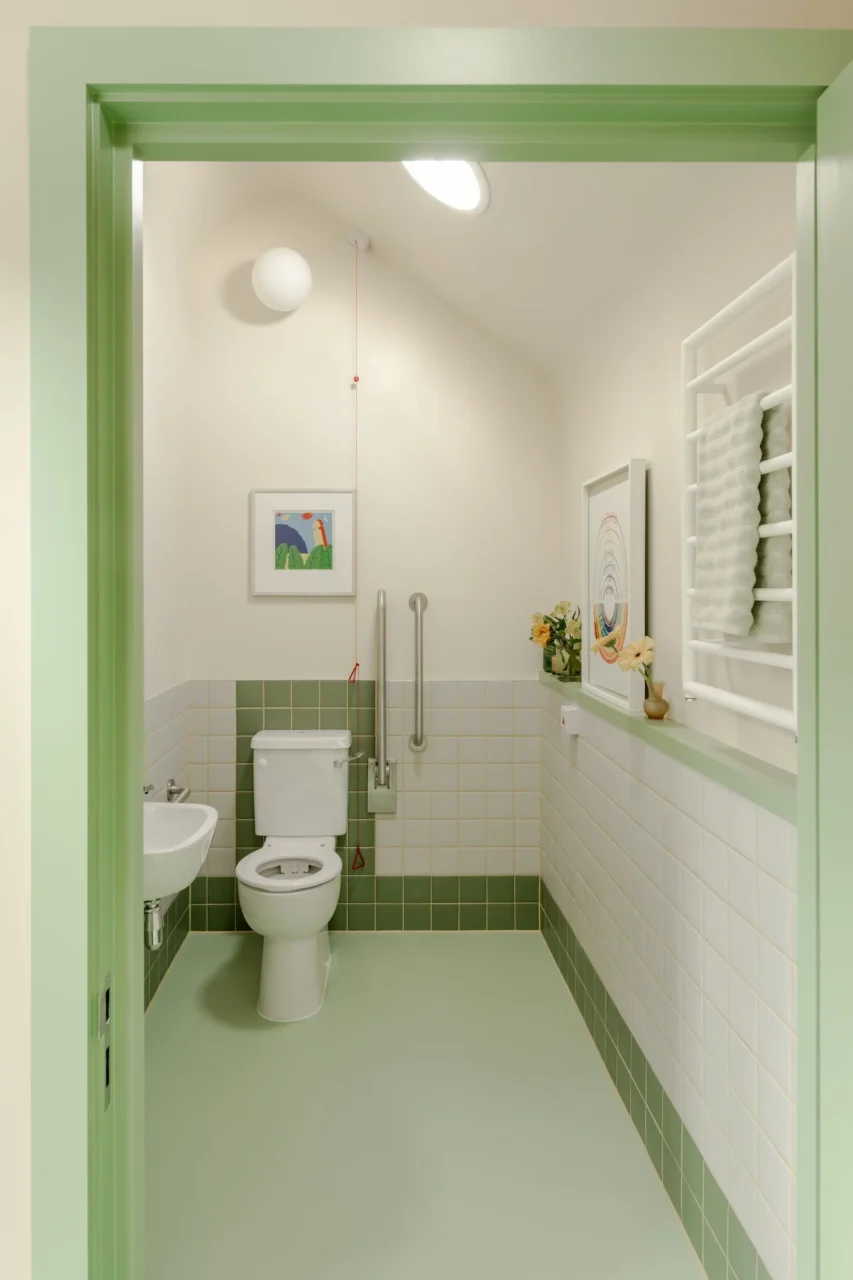 Open-plan office with colour-coded zones and full-height storage