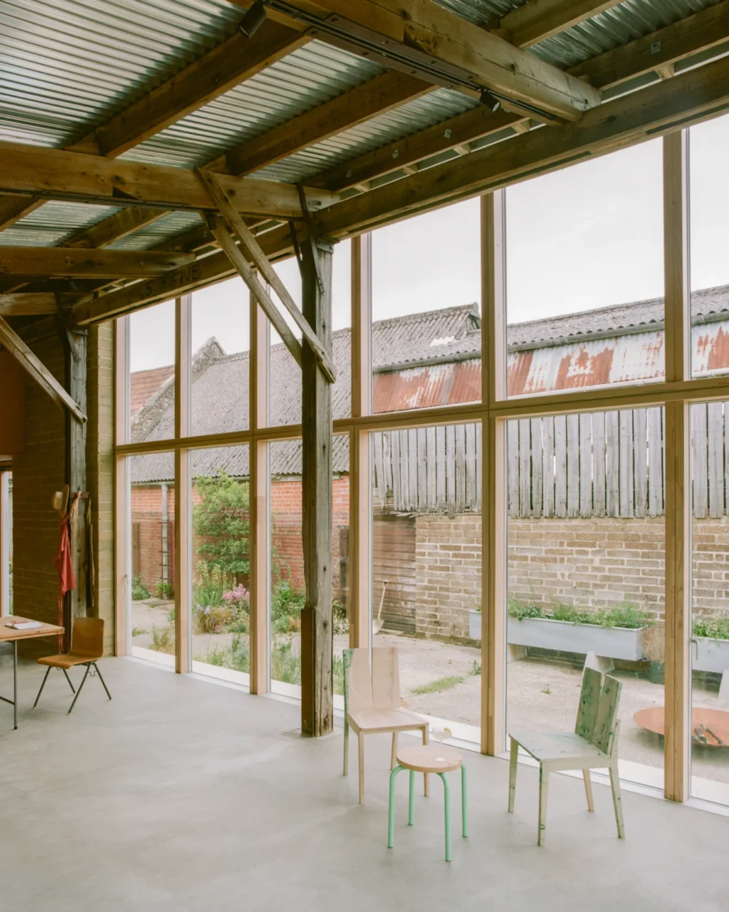 Weathered barn converted into a three-bedroom family home among farmland