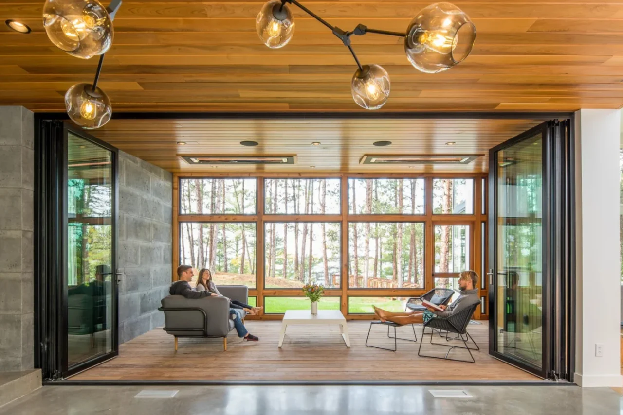 Glass-walled dining room at the core of the Northern Lake Home with lake views