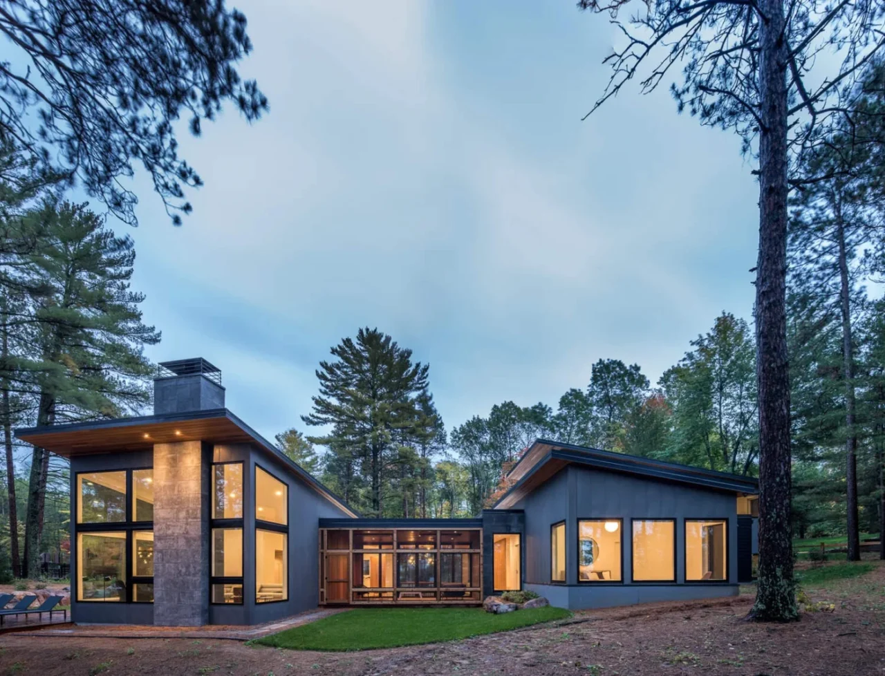 Dark exterior of grey, black, stone and wood blending into the forest in northern Minnesota