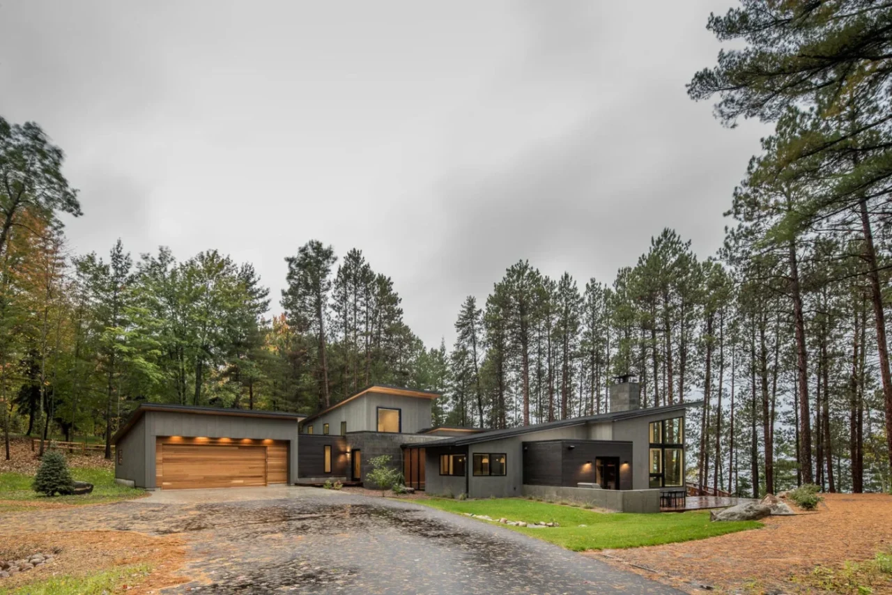 Northern Lake Home by Strand Design among the trees