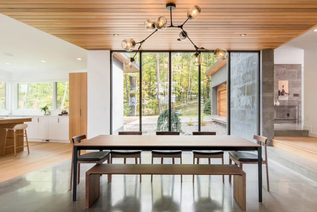 Dining area separated from an enclosed porch by an operable glass wall