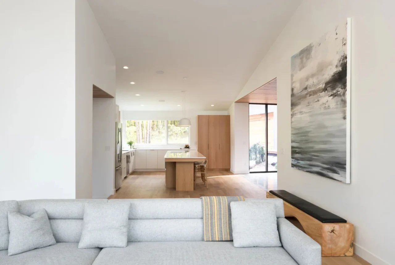 Living room with wraparound windows and a fireplace