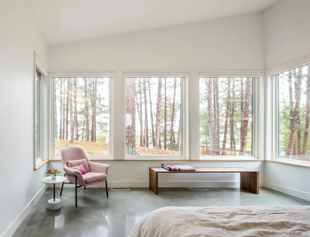 Bedroom with windows wrapping around one end of the room