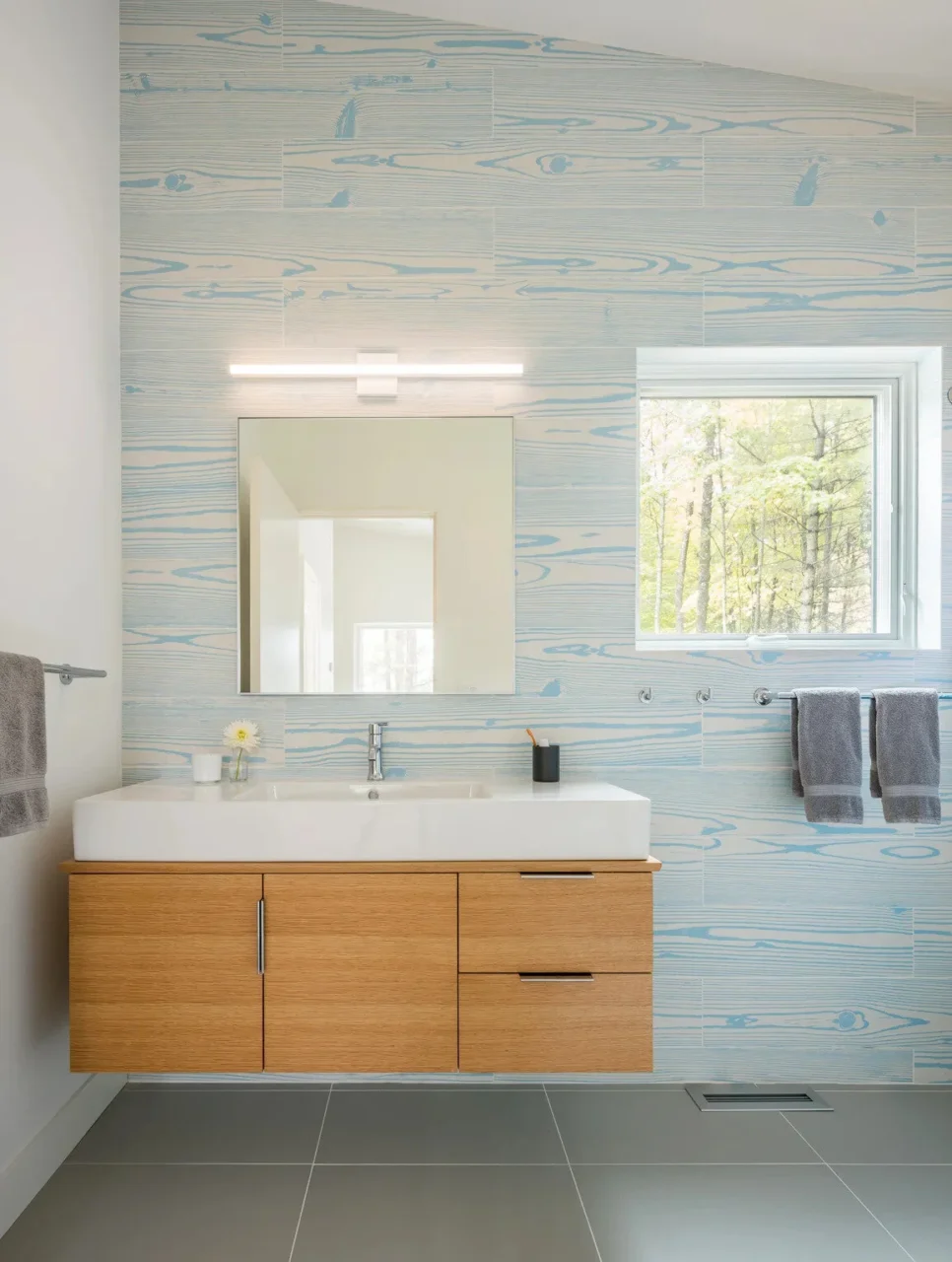 Bathroom with a feature wall of light blue wood-grain tiles