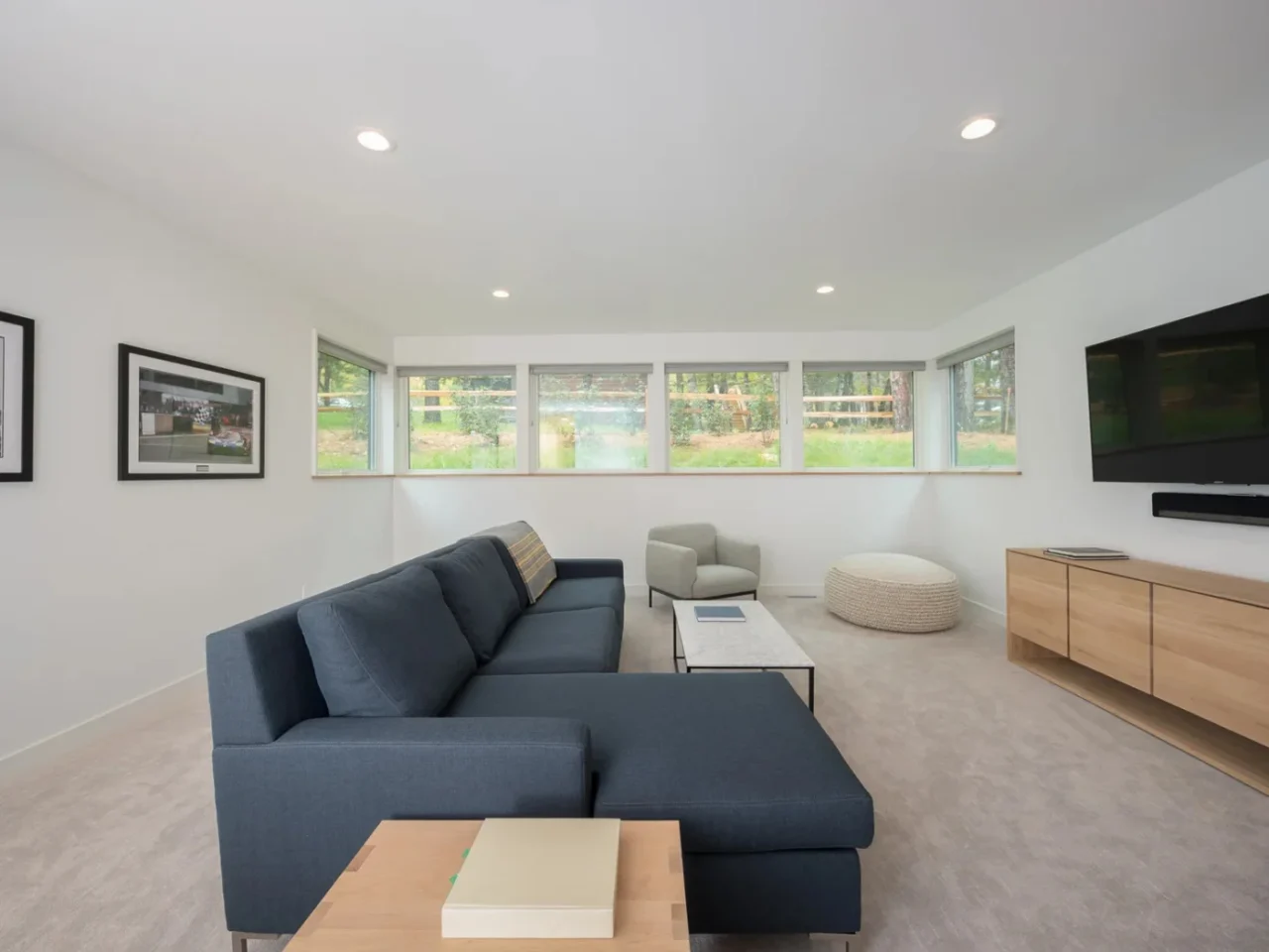 Media room with a large couch and a window